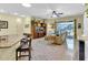 Cozy living room with tile flooring, entertainment center, and sliding glass doors to the patio at 8202 Pinewood Run Ct, Tampa, FL 33647
