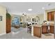 Open-concept living room featuring tile floors, comfortable seating, and kitchen with granite countertops at 8202 Pinewood Run Ct, Tampa, FL 33647