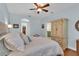 Comfortable main bedroom features an ensuite bathroom, wood flooring, and neutral wall color at 8202 Pinewood Run Ct, Tampa, FL 33647