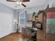 Well-lit office with wood floors, white closet doors, and built-in shelves and desk at 8202 Pinewood Run Ct, Tampa, FL 33647