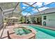Screened pool area with brick patio, hot tub, in ground pool, and outdoor dining at 8202 Pinewood Run Ct, Tampa, FL 33647