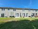 Backyard featuring a green lawn, patio, and the rear of the home with multiple sliding doors at 8796 Christie Dr, Largo, FL 33771