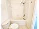 Bathroom featuring a tub with shower and a white toilet with tile flooring at 8796 Christie Dr, Largo, FL 33771