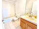 Bathroom featuring a shower/tub combo, tile floors, single vanity with wood cabinet, and large mirror at 8796 Christie Dr, Largo, FL 33771