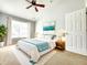 Stylishly decorated bedroom with natural light, a modern ceiling fan, and neutral colored decor at 8796 Christie Dr, Largo, FL 33771