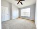Spacious bedroom with neutral carpet, a ceiling fan, and a large window at 8796 Christie Dr, Largo, FL 33771
