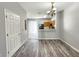 Open dining area adjacent to the kitchen, featuring modern flooring and stylish lighting at 8796 Christie Dr, Largo, FL 33771