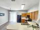 Bright kitchen features wooden cabinets, black appliances, and a view to the patio at 8796 Christie Dr, Largo, FL 33771