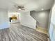 Spacious living area featuring wood floors, a staircase, and an open view to the kitchen at 8796 Christie Dr, Largo, FL 33771