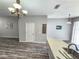 Open-concept living room featuring hardwood floors, pendant lighting, and neutral paint at 8796 Christie Dr, Largo, FL 33771