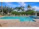 Relaxing community pool area with plenty of seating and beautiful landscaping at 8796 Christie Dr, Largo, FL 33771