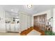 Stylish foyer with hardwood floors, a mirrored bar area, and ample closet space at 919 Seddon Cove Way # 919, Tampa, FL 33602