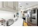 Updated kitchen featuring stainless steel appliances, quartz countertops, and ample storage space at 919 Seddon Cove Way # 919, Tampa, FL 33602
