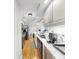 Efficient kitchen with stainless appliances, white cabinets, quartz countertop, and wood floors at 919 Seddon Cove Way # 919, Tampa, FL 33602