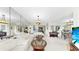 Spacious living area with mirrored wall, comfortable seating, piano and dining area for seamless entertaining at 919 Seddon Cove Way # 919, Tampa, FL 33602