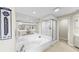 Bright main bathroom with a large tub, walk-in shower, and vanity at 919 Seddon Cove Way # 919, Tampa, FL 33602