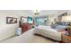 Bright main bedroom features balcony access, neutral carpet, and wood dresser at 919 Seddon Cove Way # 919, Tampa, FL 33602