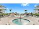 Community pool and spa surrounded by chairs and palm trees at 919 Seddon Cove Way # 919, Tampa, FL 33602