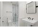 Bathroom features a marble walk-in shower, pedestal sink, black hardware, and tiled floors at 927 Anchorage Rd, Tampa, FL 33602