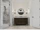 Bathroom featuring a vanity with marble countertop, a decorative mirror, and a glass door shower at 927 Anchorage Rd, Tampa, FL 33602