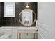 Contemporary bathroom with gold fixtures, patterned wallpaper, and marble countertops at 927 Anchorage Rd, Tampa, FL 33602