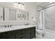 Well lit bathroom offering double sinks, decorative mirror and a shower and tub combination at 927 Anchorage Rd, Tampa, FL 33602