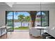 Dining room with waterfront views, modern light fixture, and access to the outdoor living area at 927 Anchorage Rd, Tampa, FL 33602