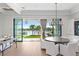 Dining room with views of the outdoor living area, pool, and waterfront at 927 Anchorage Rd, Tampa, FL 33602