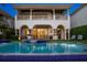 Luxury home featuring a swimming pool, covered patio, arched openings, and manicured lawn at 927 Anchorage Rd, Tampa, FL 33602