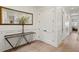 Hallway featuring a wooden floor, white walls, a wooden table with mirror and a hallway entrance at 927 Anchorage Rd, Tampa, FL 33602