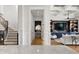 Interior view showcasing the staircase, powder room, living room and coffered ceilings at 927 Anchorage Rd, Tampa, FL 33602