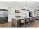 Open concept kitchen with stainless steel appliances, island with seating, and modern light fixture at 927 Anchorage Rd, Tampa, FL 33602