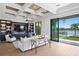 Living room with built-in shelving, coffered ceilings, and access to the outdoor living space at 927 Anchorage Rd, Tampa, FL 33602