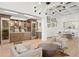 Bright open concept living room with a built-in wet bar, light wood floors, and skylights at 927 Anchorage Rd, Tampa, FL 33602