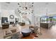 Spacious living room boasts modern light fixture, sleek staircase, fireplace, and adjacent open concept kitchen at 927 Anchorage Rd, Tampa, FL 33602