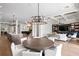 Spacious open-concept living room with coffered ceilings, modern light fixture, and access to the kitchen at 927 Anchorage Rd, Tampa, FL 33602