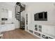Spacious living area with spiral staircase, built-in shelves, and entertainment center at 927 Anchorage Rd, Tampa, FL 33602