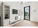 Bright living room with built-in shelves and view to outdoor patio with fountain at 927 Anchorage Rd, Tampa, FL 33602