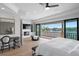 Bedroom with fireplace, balcony access, desk, and ceiling fan at 927 Anchorage Rd, Tampa, FL 33602