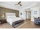 Calm main bedroom with wood floors, ceiling fan, accent wall, and bench at 927 Anchorage Rd, Tampa, FL 33602