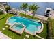 Aerial shot of luxurious pool with spa, lush landscaping, and views of the canal at 927 Anchorage Rd, Tampa, FL 33602