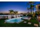 Amazing backyard with a pool, spa, lush green landscaping, and waterfront view with palm trees at 927 Anchorage Rd, Tampa, FL 33602