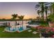 Gorgeous waterfront property featuring a pool, spa, and lush tropical landscaping at sunset at 927 Anchorage Rd, Tampa, FL 33602