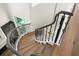Elegant curved staircase with wrought iron railing and wood steps at 927 Anchorage Rd, Tampa, FL 33602