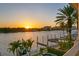 Breathtaking waterfront view at sunset, highlighting the property's private docks and palm trees at 927 Anchorage Rd, Tampa, FL 33602