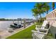 Relaxing waterfront featuring a private dock, boat, lush landscaping, and comfortable lounge chairs at 927 Anchorage Rd, Tampa, FL 33602