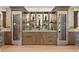 A sleek wet bar with wine fridges, shelving, and cabinetry makes this home an entertainer's dream at 927 Anchorage Rd, Tampa, FL 33602