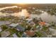 Aerial view of a waterfront community showcasing a house with a beautiful backyard and surrounding waterways at 935 Eden Isle Ne Dr, St Petersburg, FL 33704