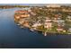 An eye-level view of the house on a waterfront canal, including its boat dock and surrounding neighborhood at 935 Eden Isle Ne Dr, St Petersburg, FL 33704
