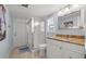 Compact bathroom with a glass-enclosed shower, vanity with granite countertop, and neutral tones at 935 Eden Isle Ne Dr, St Petersburg, FL 33704